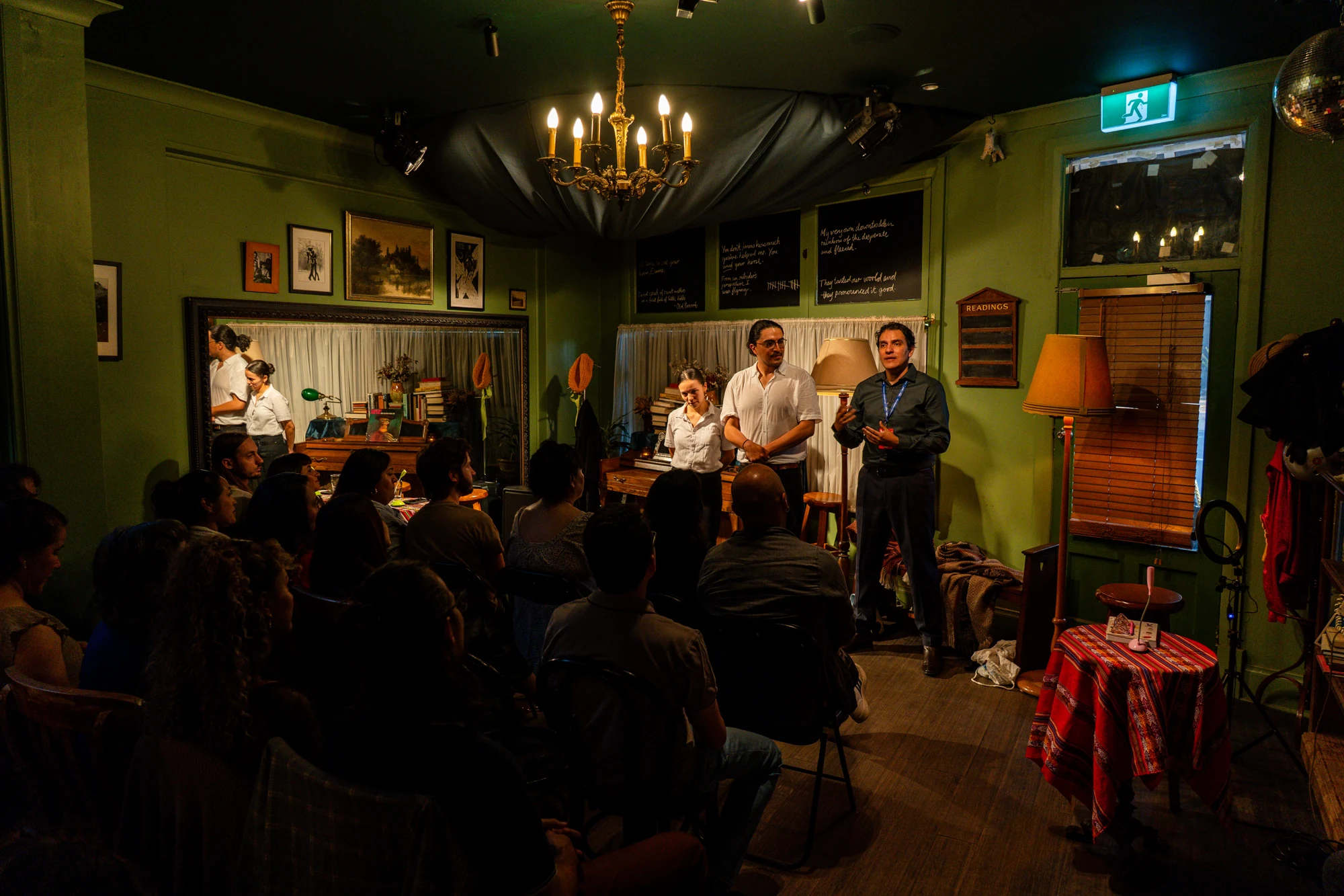 AMARTE team presenting to an audience in an intimate cultural space.
